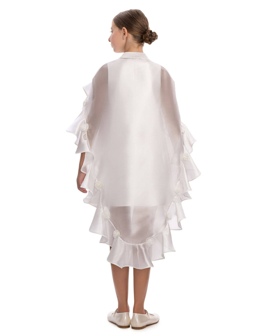 girl wearing a white ruffled dress on a white background
