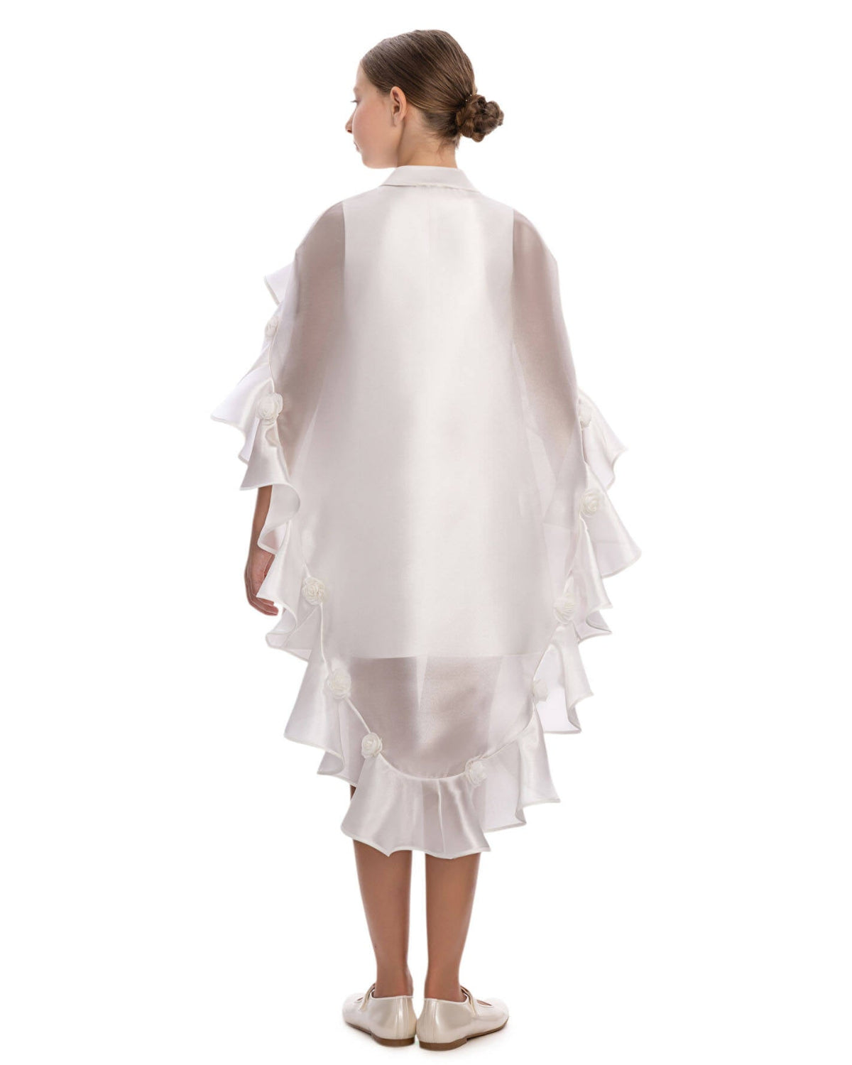girl wearing a white ruffled dress on a white background